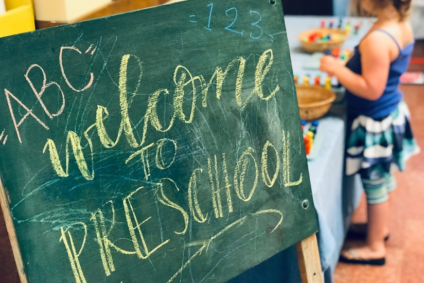 University-Ravenna Cooperative Preschool - Welcome to preschool chalkboard next to colorful sorting station